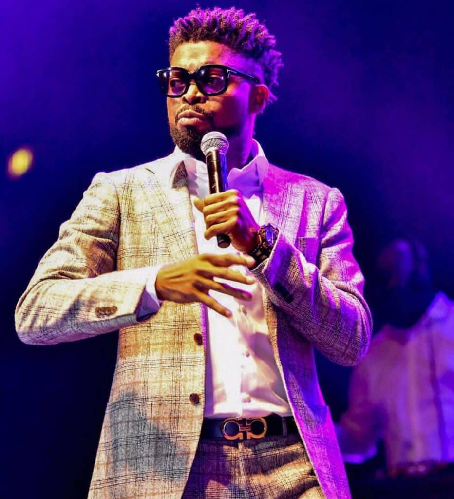 a picture of basketmouth holding a microphone at a show