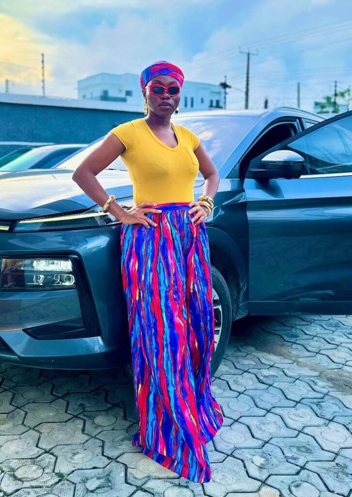 a picture of taaooma posing in front of her car